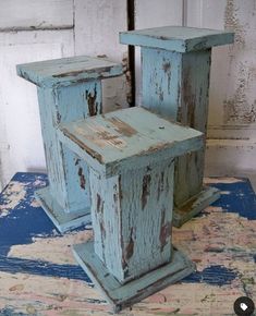 two old wooden chairs sitting on top of a blue rug in front of a white door