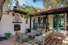 an outdoor patio with chairs, table and fire place