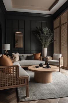 a living room with black walls and wooden furniture