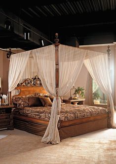 a large bed with white drapes on top of it