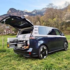 an suv with its hood open on the grass