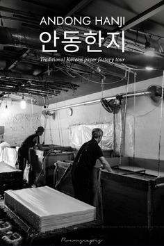 black and white photo of two men working in a factory