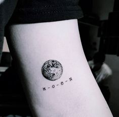 a small moon tattoo on the left inner arm