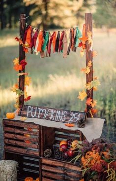 an outdoor display with pumpkins and fall leaves