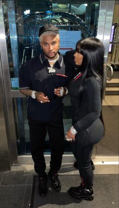 a man and woman standing in front of an elevator