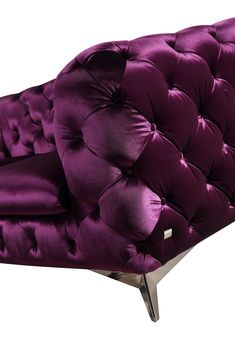 an upholstered purple chair with metal legs