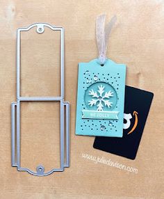 a metal frame with a snowflake on it next to a passport and a card holder