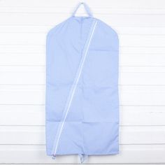 a blue and white checkered garment bag hanging on a wall