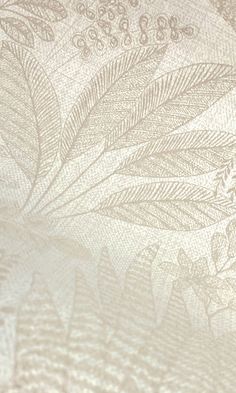 a close up view of an ornate design on a sheet of paper with some flowers and leaves