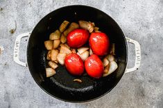 tomatoes and onions are being cooked in a skillet