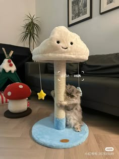 a cat is playing with a toy on the floor in front of a mushroom house