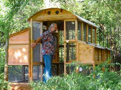 a man standing in the doorway of a chicken coop