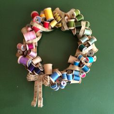 a bunch of spools of thread are arranged in a wreath