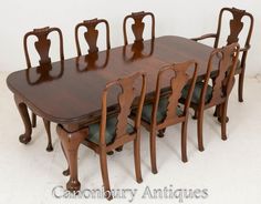 a wooden dining table with six chairs and one chair that is missing the back end