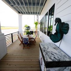 a porch with chairs and tables on it