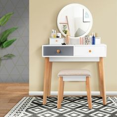 a vanity table with a mirror and stool in front of it on a rug next to a potted plant