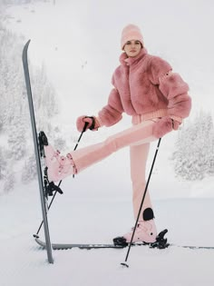 a woman in pink is posing on skis