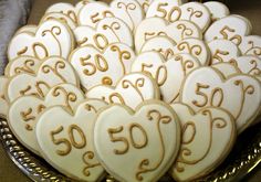 a platter filled with heart shaped cookies on top of a table