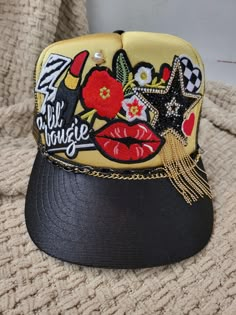 A lil' Bougie foam snapback trucker hat for her. Vibrant gold hat with gold and red accents. Has embroidered patches and a double hat chain. Trucker Cap Outfit, Trucker Hat Designs, Hat Chain, Classy Hats, Baseball Cap Outfit, Gold Hat, Cap Outfit, Custom Trucker Hats, Gold Hats