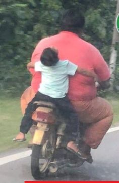 a man riding on the back of a motorcycle with a child sitting on it's back