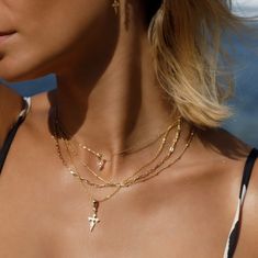 Elevate your style with the Naxos Cross Pendant in 14k Gold Vermeil, a bold piece that combines elegance with a touch of edge. This statement pendant features a sleek cross design, encrusted with pave cubic zirconia stones that catch the light beautifully, adding just the right amount of sparkle. Whether you’re dressing up or keeping it casual, the Naxos Cross Pendant is a versatile accessory that brings a touch of modern sophistication to any outfit. Perfect for those who love making a subtle y Cross Necklace Gold, August Birthstone Jewelry, July Birthstone Jewelry, Gold Cross Necklace, Gold Cross Pendant, Dainty Gold Necklace, Demi Fine Jewelry, Jewelry Ring Box, Cross Design