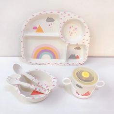 a small child's meal set with cups and spoons