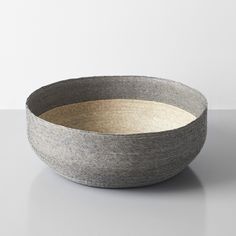 a gray and white bowl sitting on top of a table