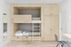 the bunk bed is made from plywood and has two sets of drawers on each side