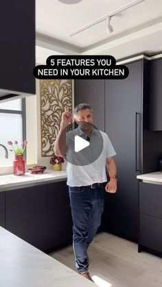 a man walking through a kitchen with the words 5 features you need in your kitchen