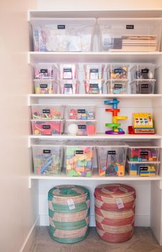 an organized pantry with plastic bins and shelves filled with toys, books, and other items