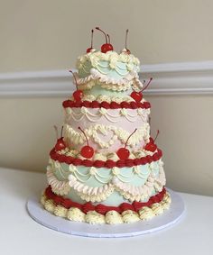 a multi layer cake with cherries on top