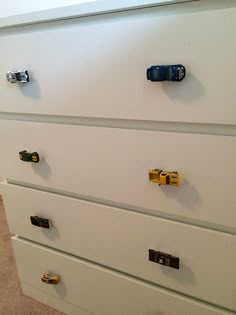 a white dresser with several drawers and knobs