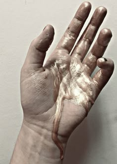 a person's hand covered in white paint