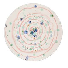 a white plate with blue and green designs on it's rim, against a white background