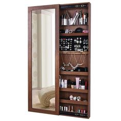 a mirror that is next to a shelf with jewelry on it