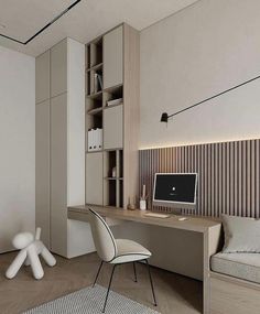 a room with a desk, chair and computer on the wall next to bookshelves