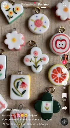 many different types of buttons are on the table with keychains attached to them