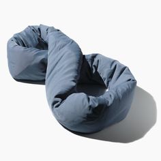 two blue bean bags sitting on top of a white floor next to each other in front of a white wall