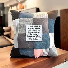 a pillow with a quote on it sitting on a table