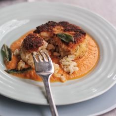 a white plate topped with food and a fork