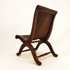 a wooden chair sitting on top of a white floor