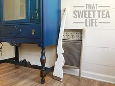 a blue cabinet sitting next to a radiator on top of a hard wood floor