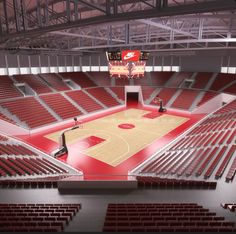 an empty basketball court with red seats