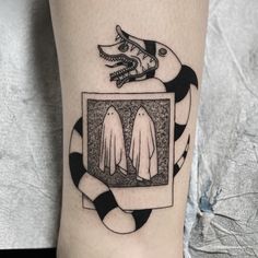 a person with a tattoo on their leg has an image of two white gloves in front of them