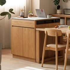 a kitchen with a laptop on the counter