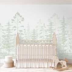 a baby's room with a crib, rocking horse and wallpaper