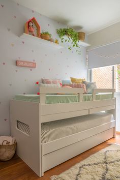 a child's bedroom with a white bunk bed and pink wall decals on the walls