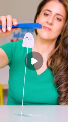 a woman holding a toothbrush with a ghost on it