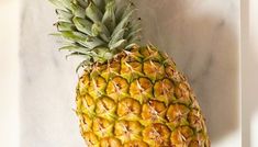 a pineapple sitting on top of a white counter