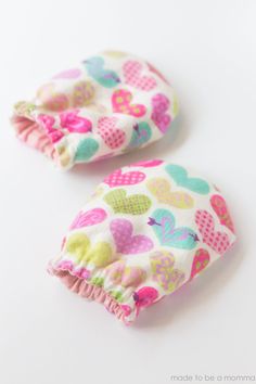 two small pieces of fabric with hearts on them are sitting next to each other in front of a white background